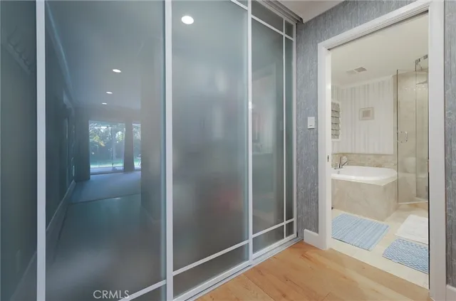 a bathroom with a tub sink double and mirror