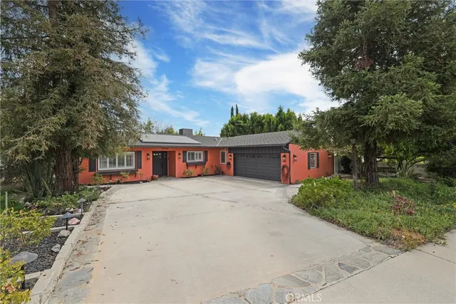 a backyard of a house with basket ball court and entertaining space