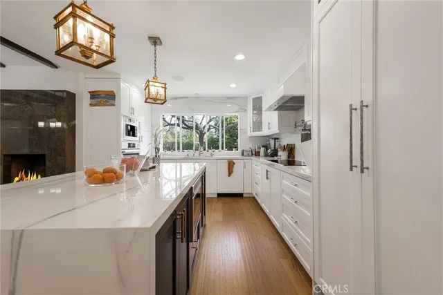a kitchen with kitchen island granite countertop lots of counter top space and stainless steel appliances