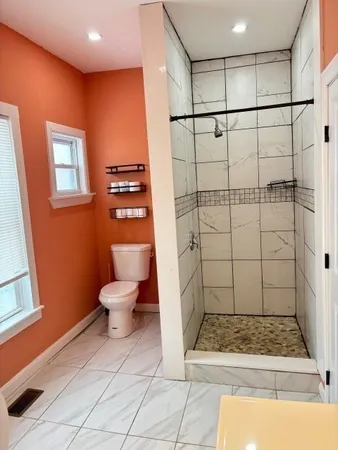a bathroom with a sink toilet and shower