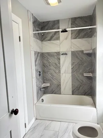 a bathroom with a shower and a bath tub