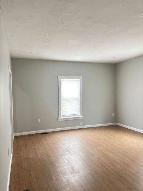 60 Silver Lake Street Athol, MA 01331 - Photo 20 of 36 an empty room with wooden floor and windows