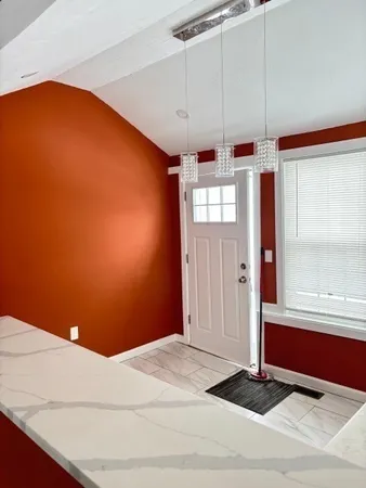 a view of a livingroom with wooden floor and window