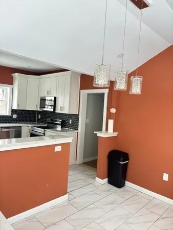 a kitchen with stainless steel appliances granite countertop a sink a stove a refrigerator and cabinets