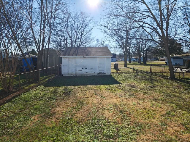 a view of a backyard with large trees