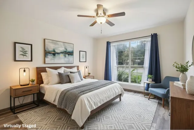 a bedroom with a large bed and a window