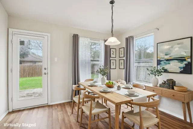 a view of a dining room with furniture window and wooden floor