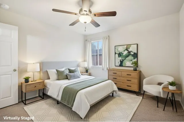 a bedroom with a bed and a chandelier fan