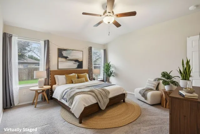 a bedroom with a bed a couch and a potted plant