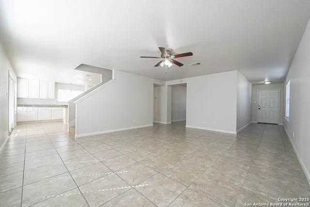a view of an empty room with a ceiling fan