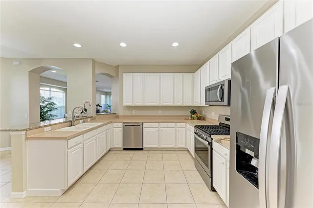 a bedroom with a large bed and a chandelier