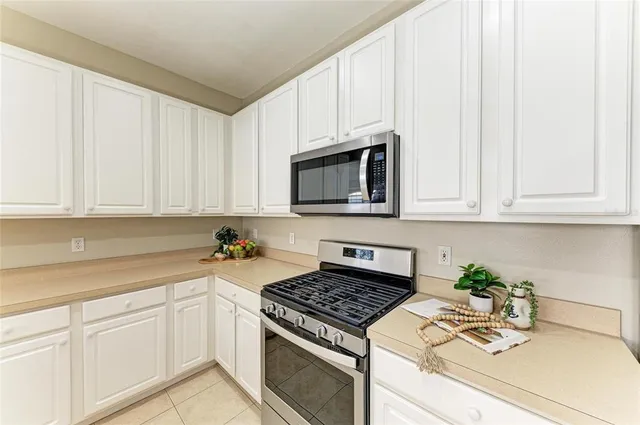 a bedroom with bed and a chandelier