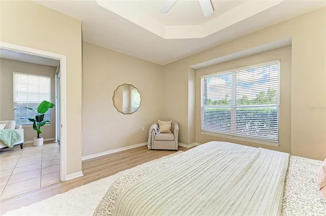 a bedroom with a bed and a chandelier