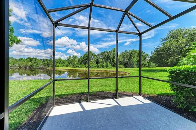 an aerial view of a house with a lake