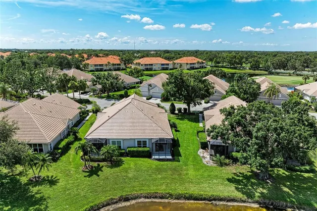 a front view of a house with a yard and potted plants