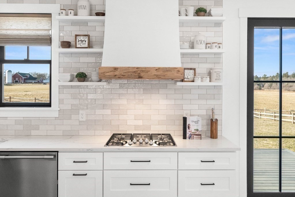 6 Woodman Road Amesbury, MA 01913 - Photo 12 of 37 a stove top oven sitting inside of a kitchen