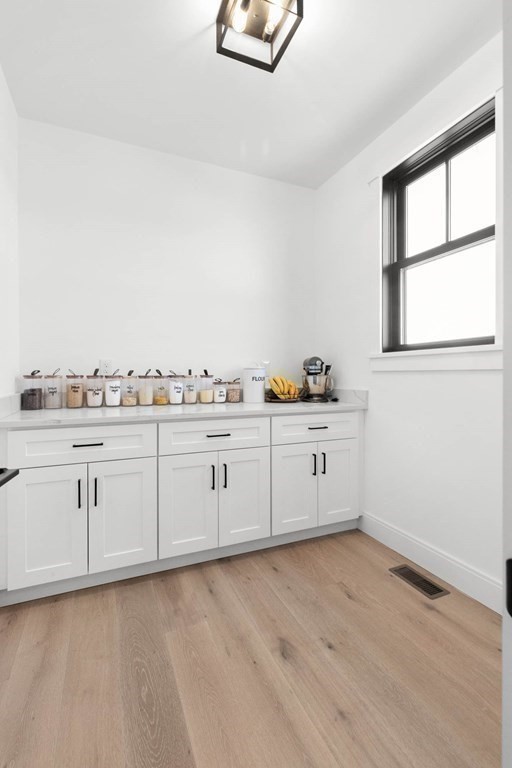 6 Woodman Road Amesbury, MA 01913 - Photo 14 of 37 a kitchen with white cabinets and window