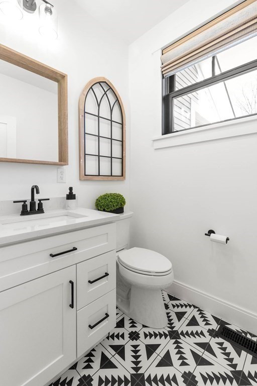 6 Woodman Road Amesbury, MA 01913 - Photo 19 of 37 a bathroom with a sink a toilet and a mirror