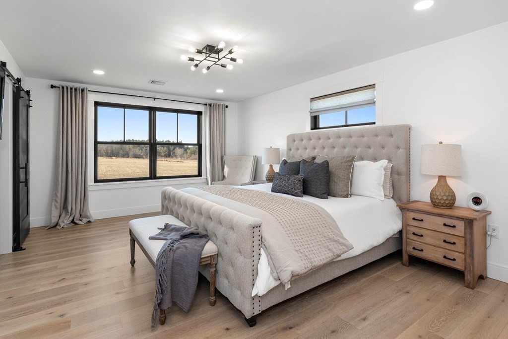 6 Woodman Road Amesbury, MA 01913 - Photo 23 of 37 a bedroom with a bed and a chandelier