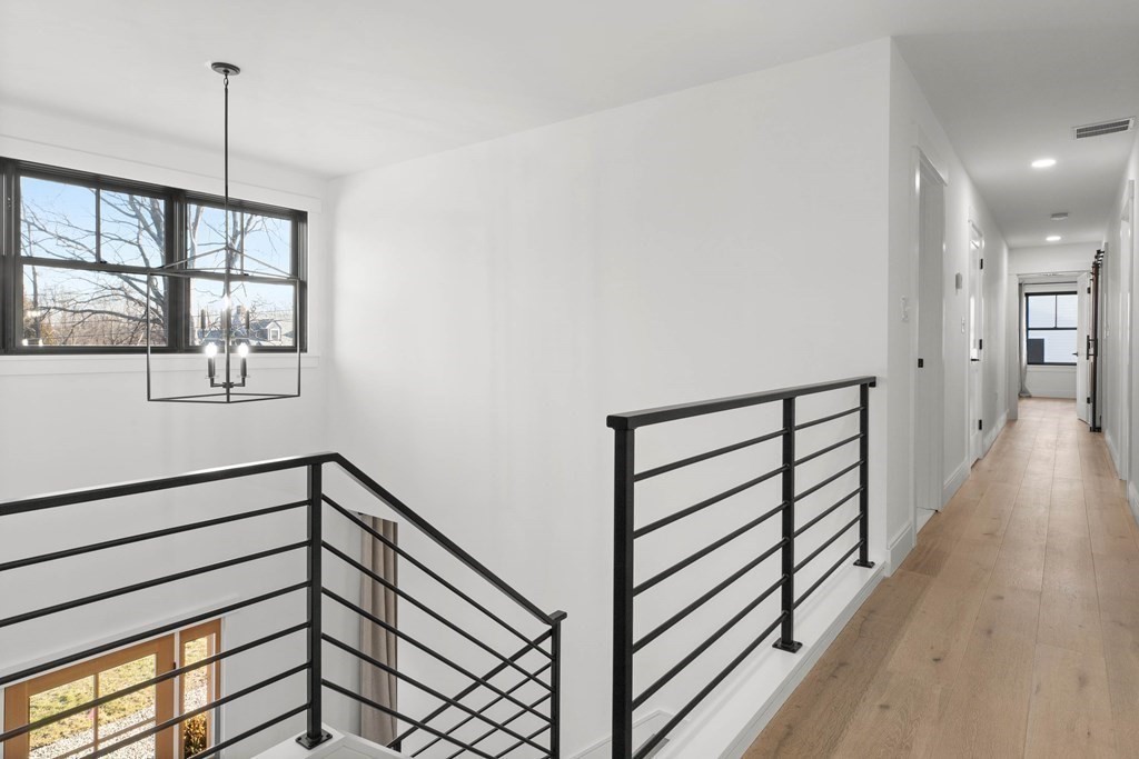 6 Woodman Road Amesbury, MA 01913 - Photo 27 of 37 a view of a hallway with wooden floor and a window