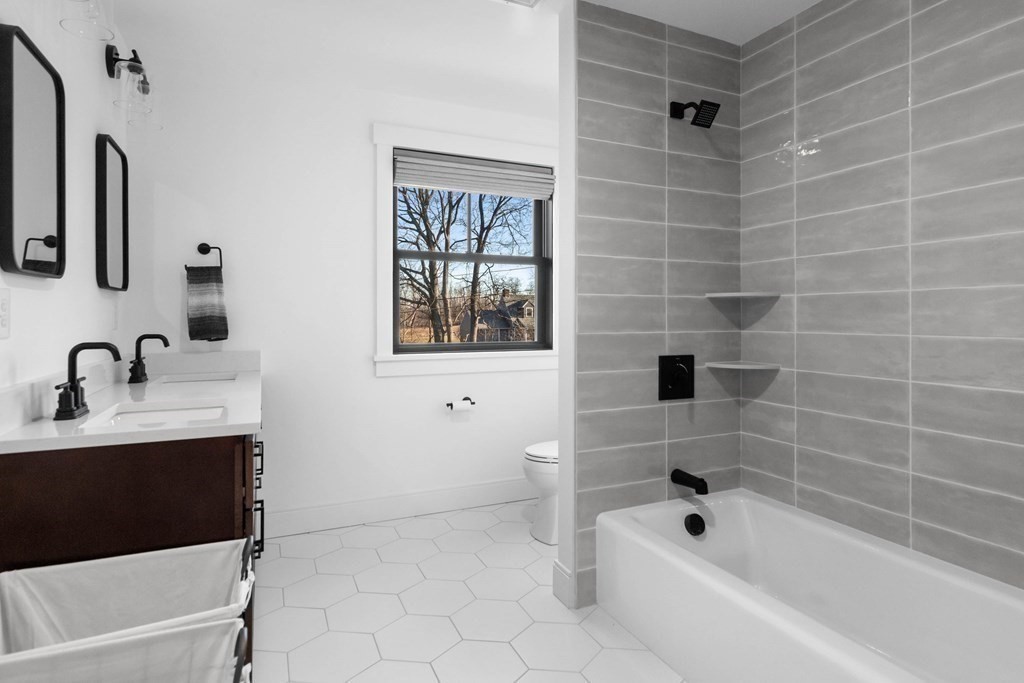 6 Woodman Road Amesbury, MA 01913 - Photo 28 of 37 a bathroom with a bathtub sink vanity and mirror