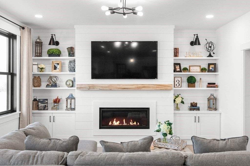 6 Woodman Road Amesbury, MA 01913 - Photo 7 of 37 a living room with furniture and a flat screen tv
