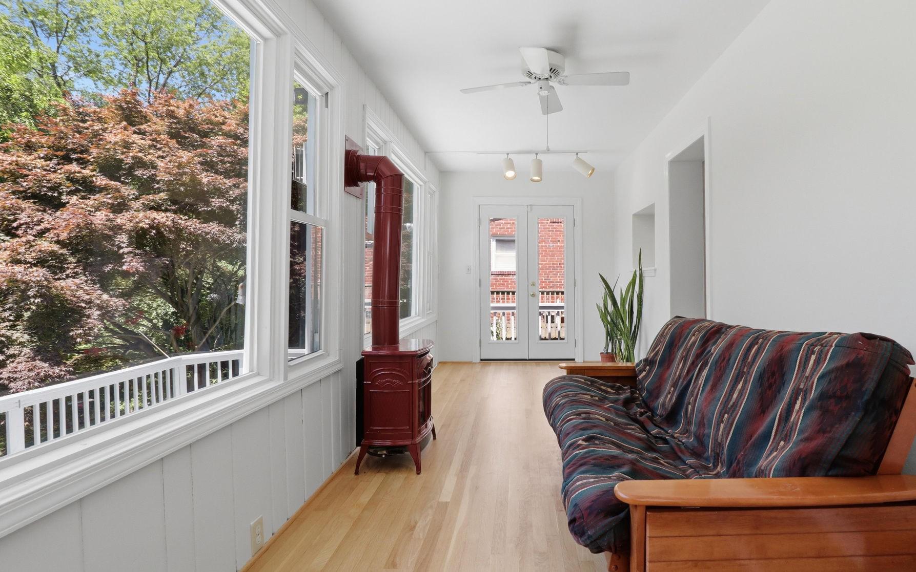 11708 Galt Avenue Silver Spring, MD 20902 - Photo 6 of 25 Sunroom featuring a charming gas potbelly stove.