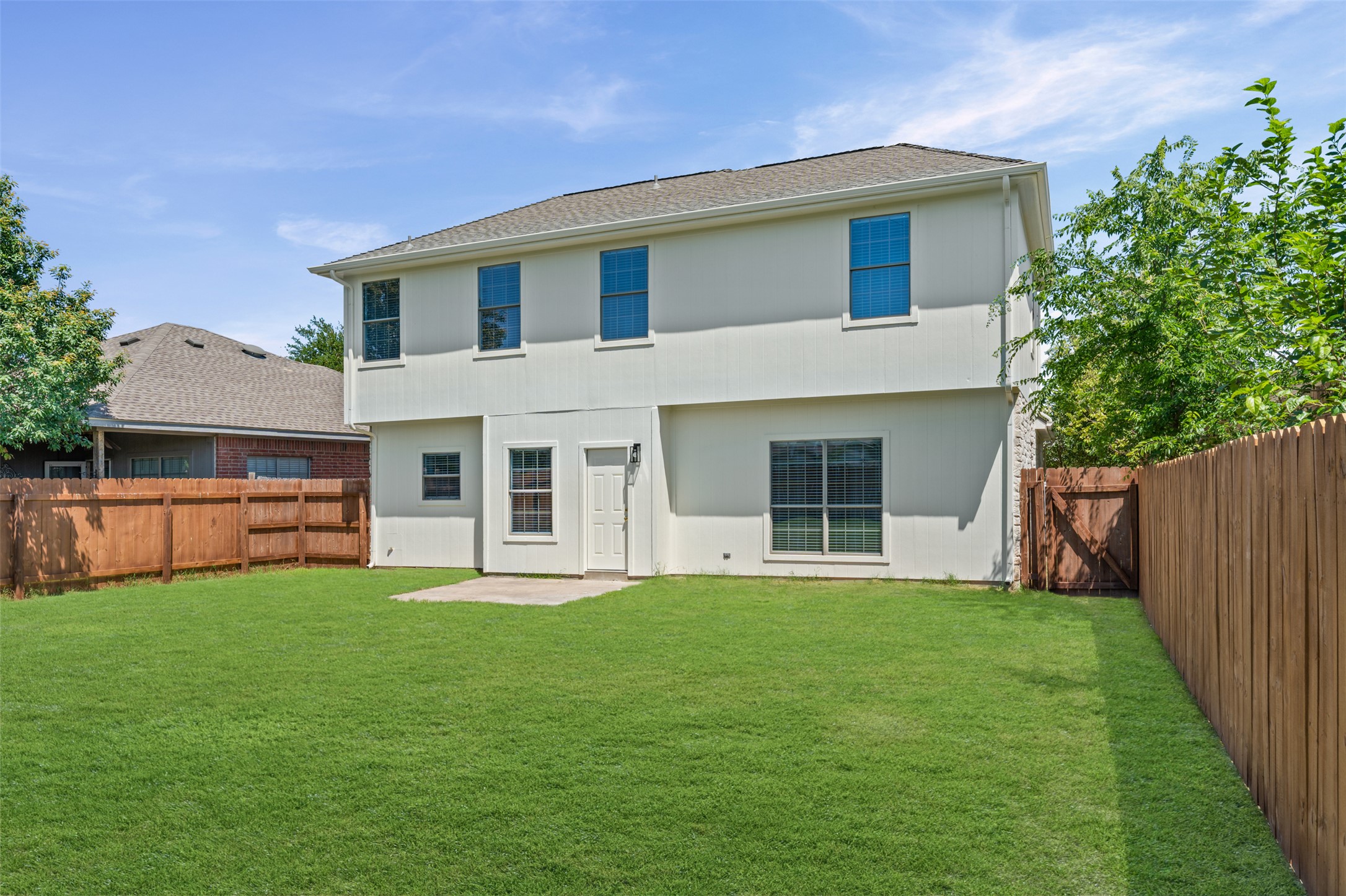 243 Engineers Pass Jarrell, TX 76537 - Photo 36 of 40 Expansive backyard featuring a manicured lawn, full privacy fencing, and a concrete patio