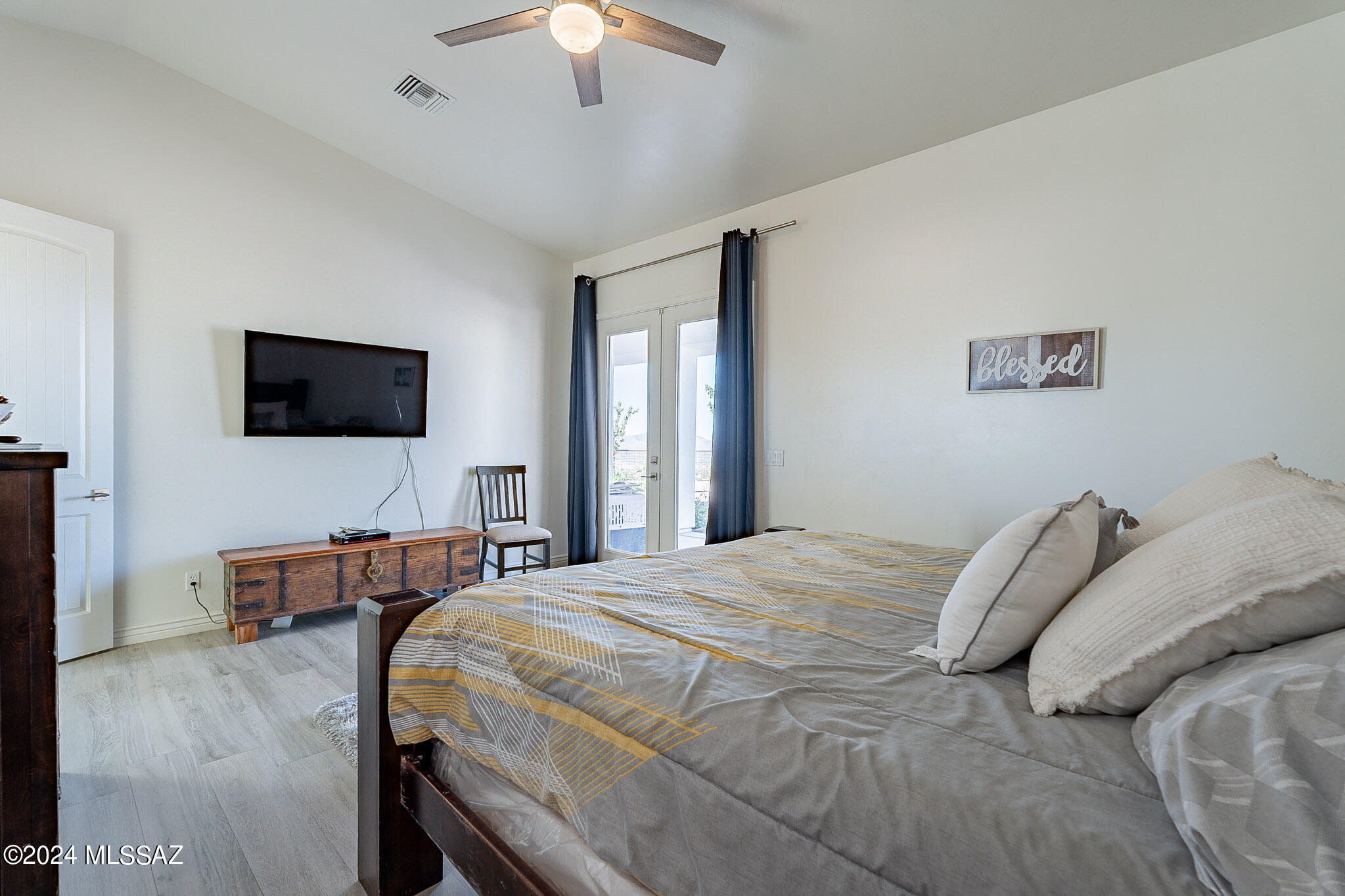 176 Avenida Ostion Rio Rico, AZ 85648 - Photo 22 of 48 a bedroom with a bed and a flat screen tv