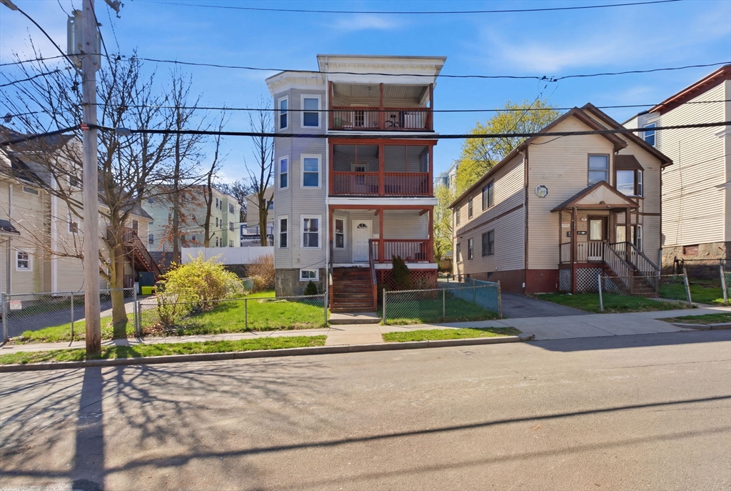 22 Deering Road, Unit 1 Boston, MA 02126 - Photo 1 of 12 a view of a white house with a yard and plants
