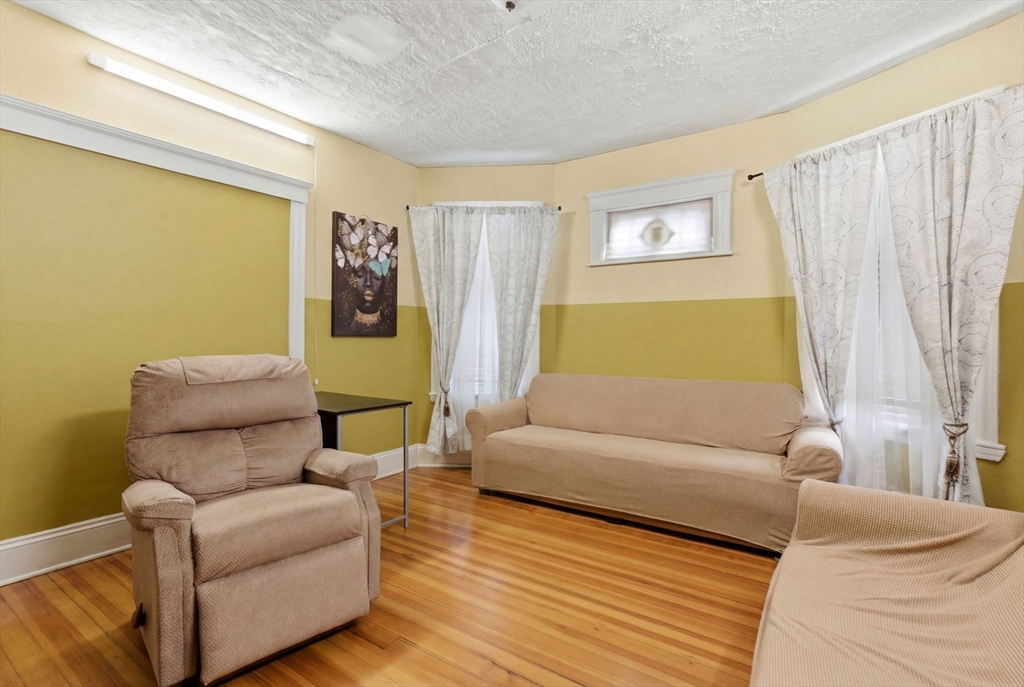 22 Deering Road, Unit 1 Boston, MA 02126 - Photo 12 of 12 a living room with furniture and a window