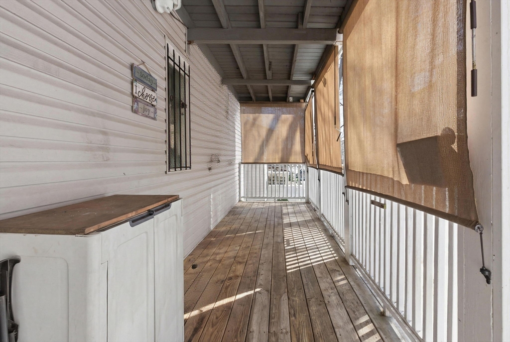 22 Deering Road, Unit 1 Boston, MA 02126 - Photo 6 of 12 a view of balcony with wooden floor and stairs