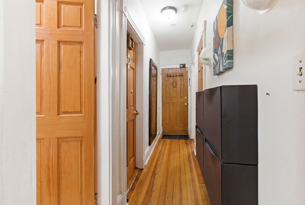22 Deering Road, Unit 1 Boston, MA 02126 - Photo 10 of 12 a view of a hallway with wooden floor and staircase