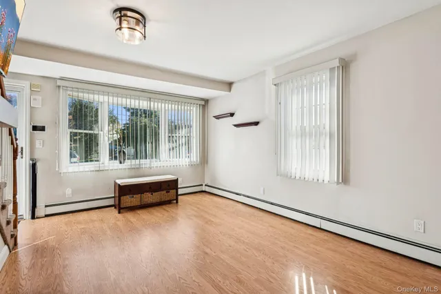 a view of a livingroom with furniture wooden floor and window