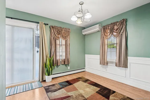 a view of a bedroom with wooden floor and windows