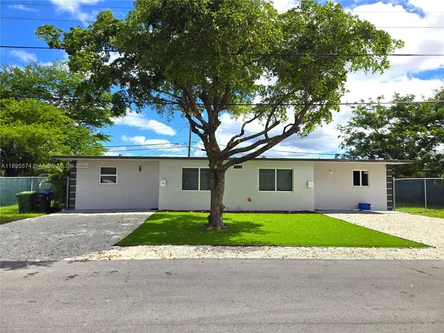 a house that has a tree in front of it