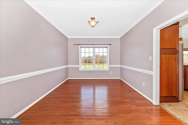 a living room with stainless steel appliances granite countertop furniture a fireplace a flat screen tv and windows