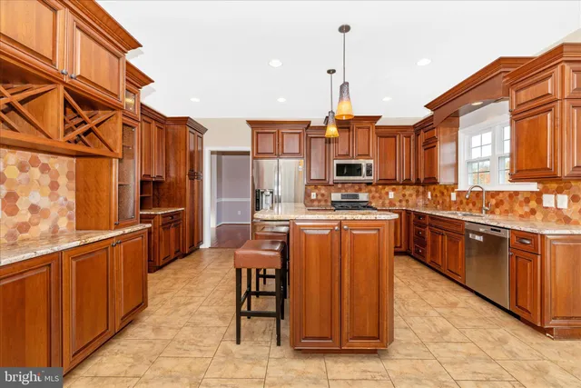 a kitchen with a stove and a wooden floor