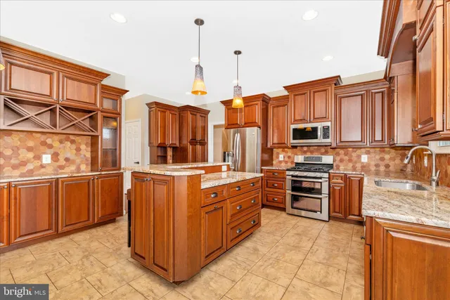 a kitchen with stainless steel appliances a refrigerator and a sink
