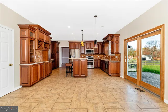 an empty room with a fireplace and windows