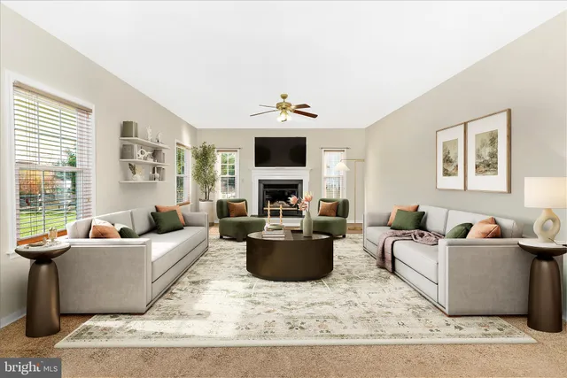 a view of a livingroom with furniture and a ceiling fan