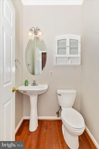 a view of a big room with windows and chandelier fan