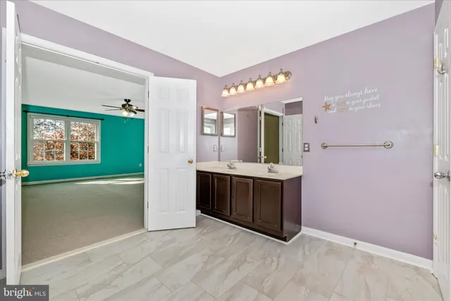 a view of an empty room with a ceiling fan