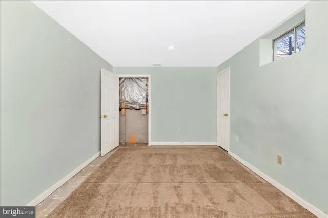 a view of a large pool with lawn chairs and a big yard