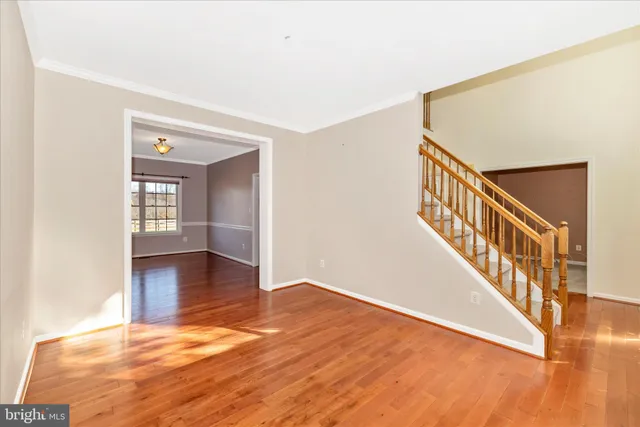 a view of an empty room with window wooden floor and a window