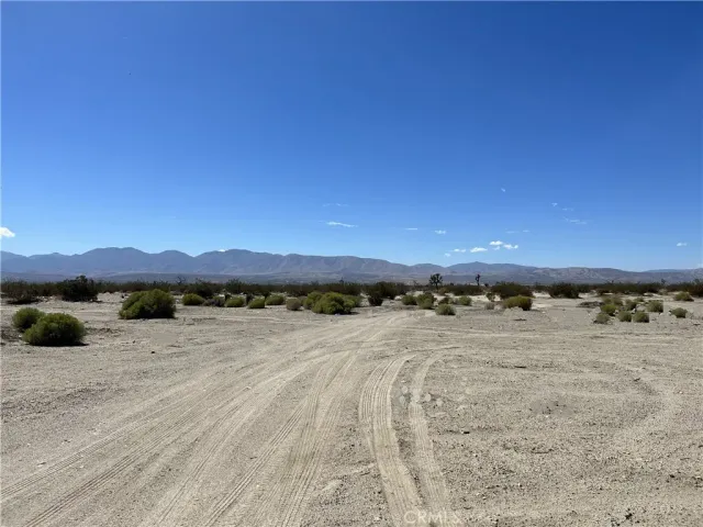 a view of an ocean beach and mountain