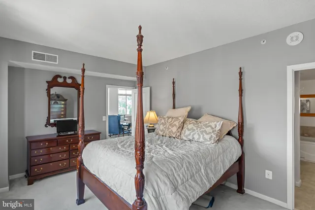 a bedroom with a bed and a dresser