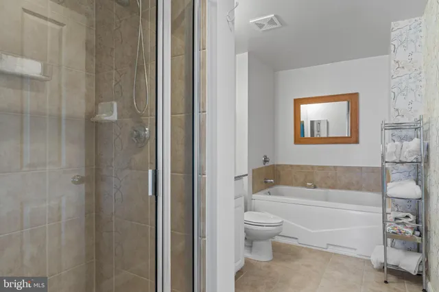 a bathroom with a toilet a sink and bathtub