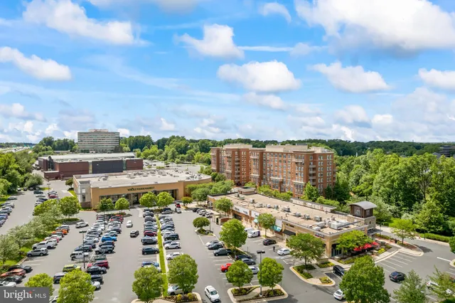 a view of a house with wooden deck and a trees