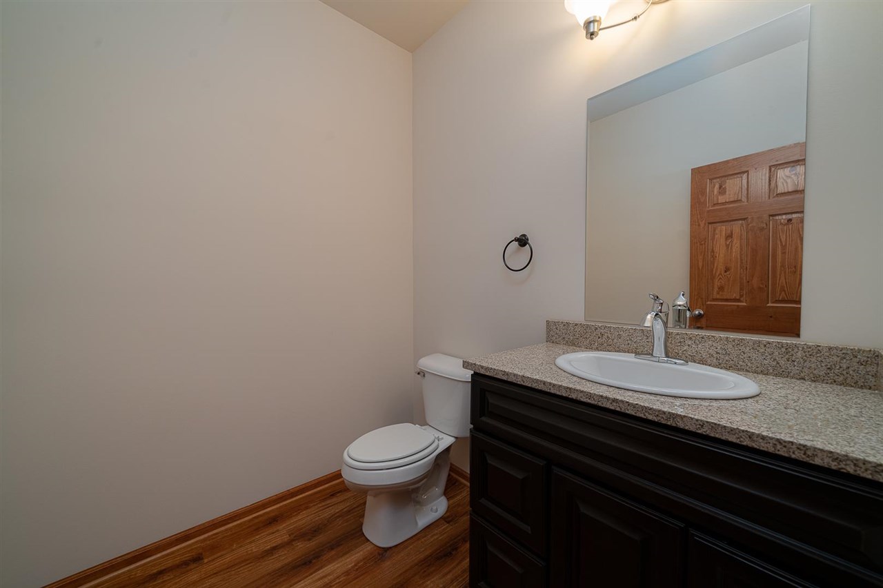 9909 Lismore Road Roscoe, IL 61073 - Photo 12 of 24 a bathroom with a granite countertop toilet sink and mirror